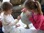 kids looking at a globe